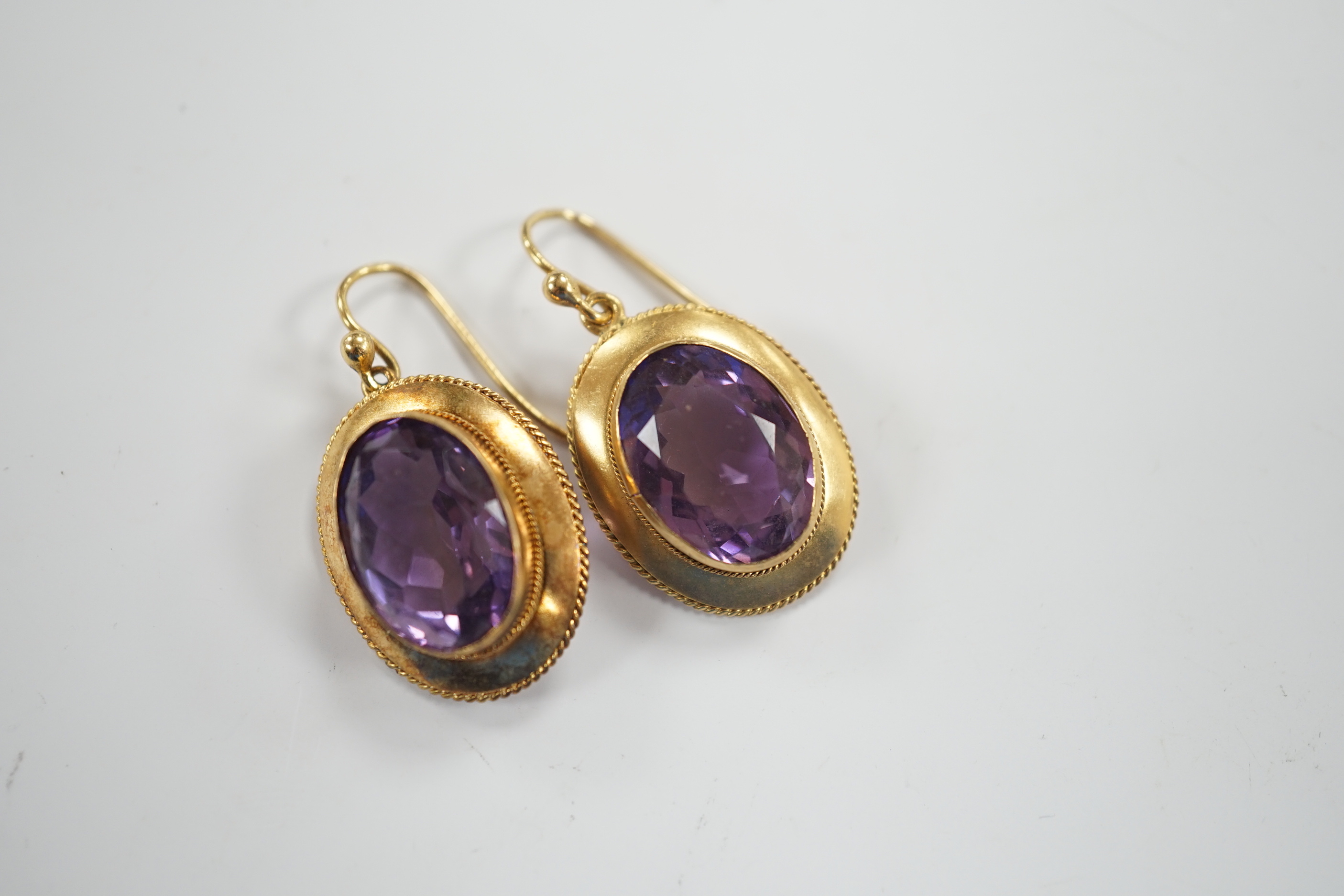 A pair of Victorian yellow metal and amethyst set oval drop earrings, 21mm, gross weight 6.3 grams.